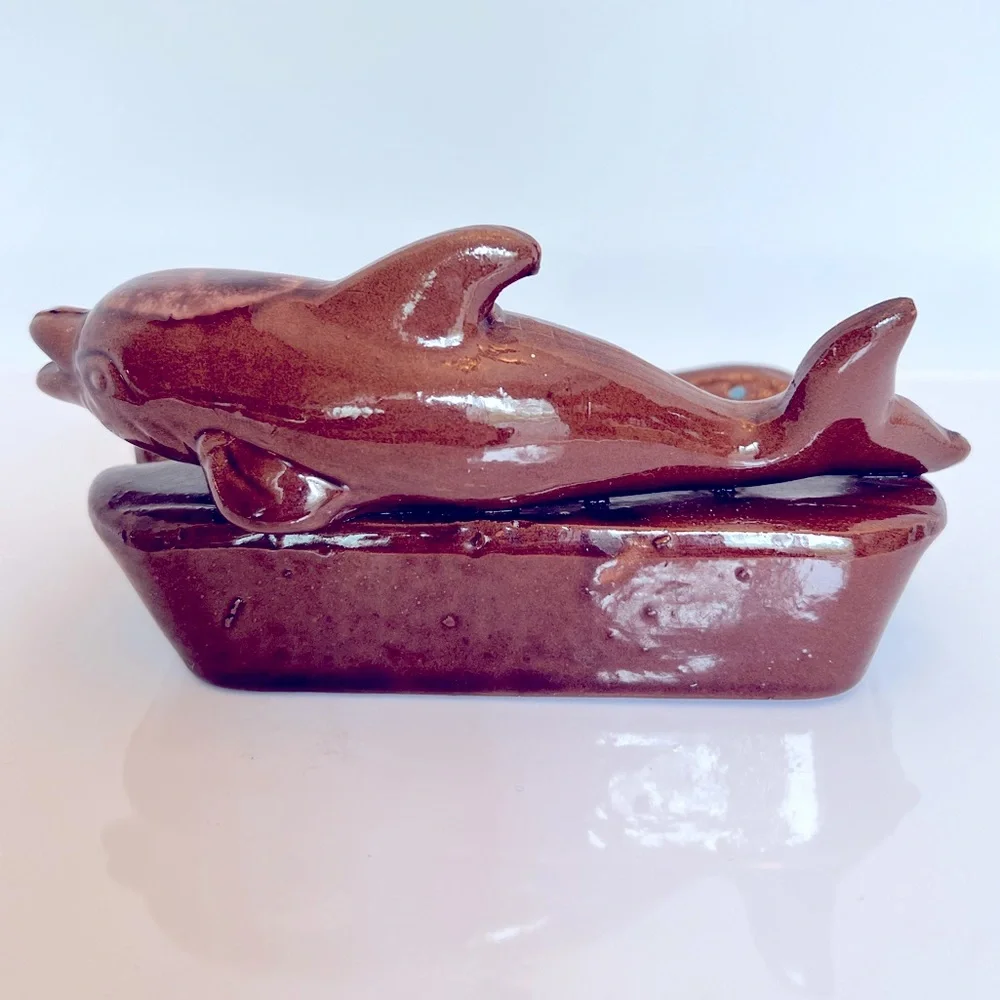 Vintage Ceramic Florida Ashtray with a Brown Dolphin Swimming in Blue Water.